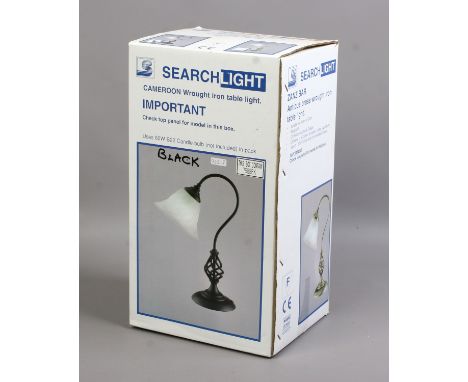 A black wrought iron work table lamp with milchglas shade.