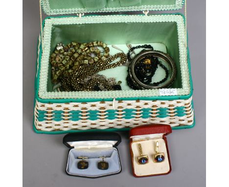 A sewing basket containing assorted costume jewellery including vintage cufflinks, beads and a white metal bangle etc.