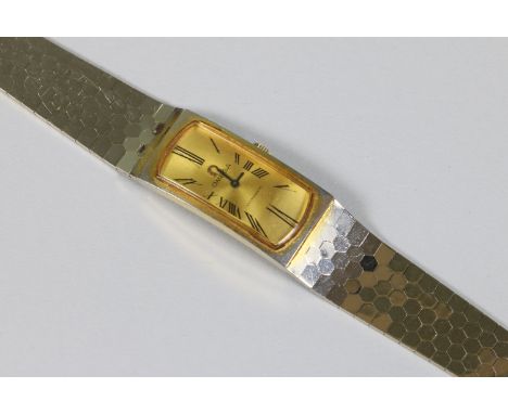 A vintage ladies Omega manual bracelet watch with Roman numeral markers and gilt dial.