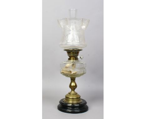 A Victorian brass based oil lamp with cut glass font and etched shade.