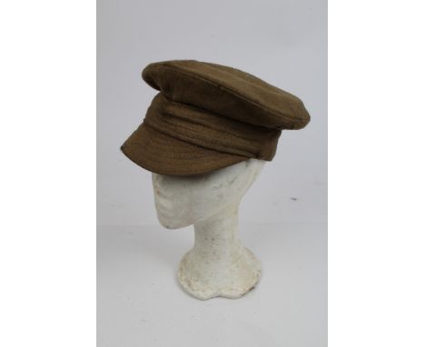 First World War British khaki trench cap, with brass side buttons, interior marked with broad arrow and numbered 183