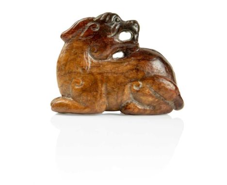 宋至元 赤褐玉獨角獸 carved in the round of a recumbent unicorn beast with its head turned onto its back with snarling expression, the 