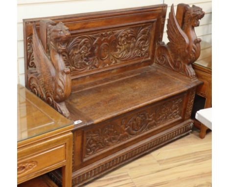 A Renaissance style carved oak box seat monks bench W.120cm