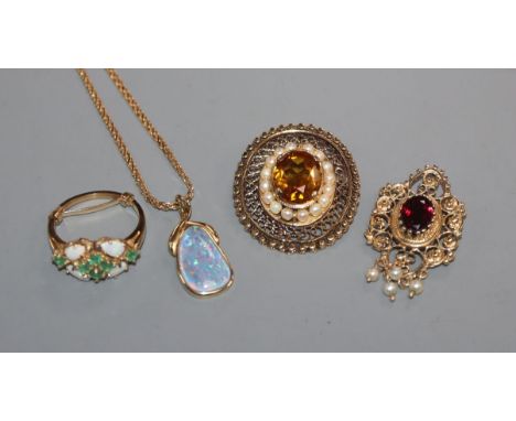 A 14k and gem set pendant, one other 14k pendant, a yellow metal and gem set brooch and a 14k ring.