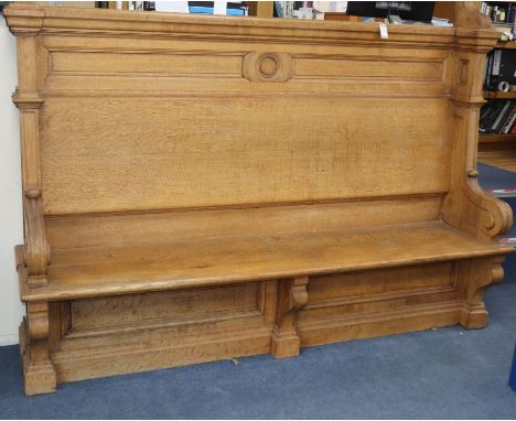 A late Victorian light oak hall seat W.220cm