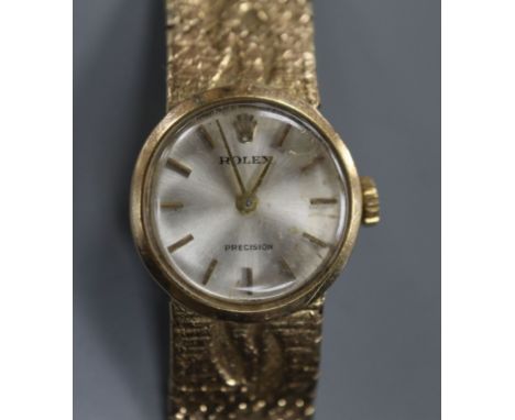 A lady's 9ct gold Rolex Precision manual wind wrist watch, on a fancy 9ct Rolex bracelet.