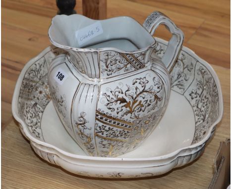 A gilt decorated jug and basin