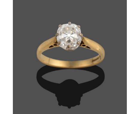 An 18 Carat Gold Diamond Solitaire Ring, the old mine cut diamond in a white claw setting, to a yellow tapered shoulder plain