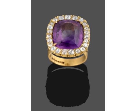 An 18 Carat Gold Amethyst and Diamond Cluster Ring, the cushion cut amethyst within a border of old cut diamonds, in yellow c