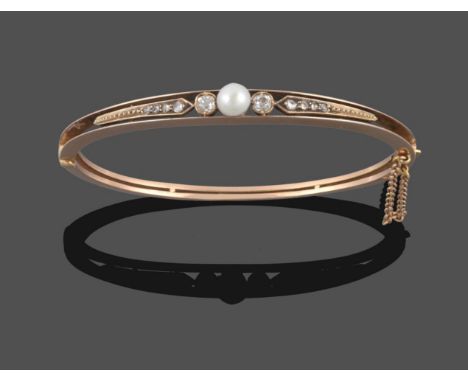 A Pearl and Diamond Bangle, circa 1900, the central three-quarter pearl with a collet set old cut diamond either side, to a r