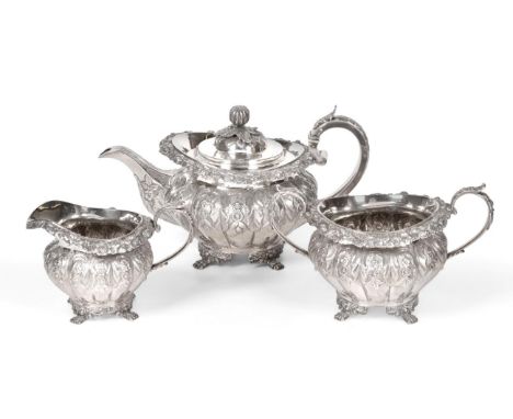 A Three-Piece George IV Irish Silver Tea-Service, by Edward Power, Dublin, 1828, each piece melon-fluted, each flute chased w