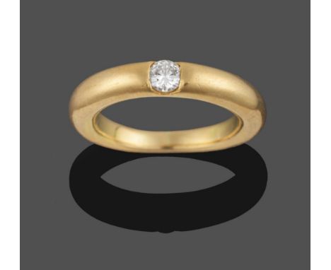 A Diamond Solitaire Ring, by Cartier, the round brilliant cut diamond tension set within a heavy gauge yellow band ring, esti