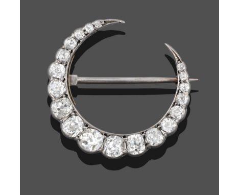 A Diamond Crescent Brooch, set throughout with graduated old cut diamonds in white claw settings, total estimated diamond wei