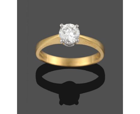 An 18 Carat Gold Diamond Solitaire Ring, the round brilliant cut diamond in a white four claw setting to yellow tapered shoul