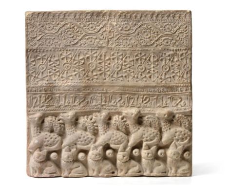 A Persian Unglazed Pottery Tile, probably 12th/13th century, moulded with geometric and foliate bands above calligraphy and a