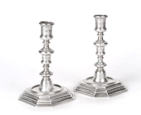 A Pair of Queen Anne Silver Candlesticks, by William Denny, London, 1702, each on stepped square base with canted corners, wi