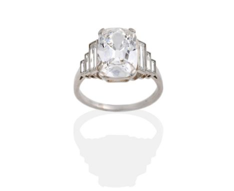 A Diamond Ring, circa 1935, a cushion cut diamond with graduated baguette cut shoulders, on a plain polished shank, finger si