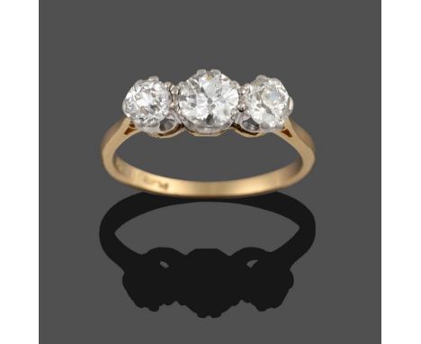 A Diamond Three Stone Ring, the graduated old cut diamonds in white double claw settings, to a yellow tapered shoulder plain 