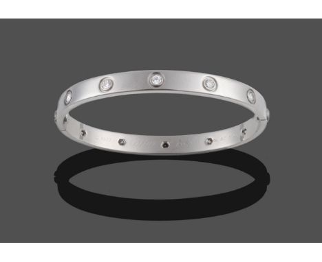 An 18 Carat White Gold Diamond Set 'Love' Bangle, by Cartier, with screw-head effect and ten round brilliant cut diamonds ins