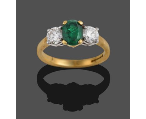 An 18 Carat Gold Emerald and Diamond Three Stone Ring, the oval cut emerald between two round brilliant cut diamonds, in yell