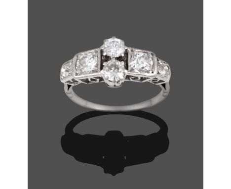 A Diamond Ring, circa 1930, two old cut diamonds vertically claw set to the centre, an old cut diamond set to each side, and 