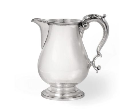 A George IV Silver Beer-Jug, by Robert Garrard, London 1826, plain baluster and on circular domed foot, with leaf-capped scro