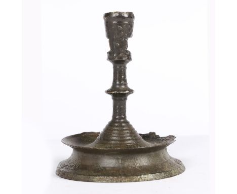 The flared socket with two large rectangular wax extraction holes, atop a discoid centred short stem, on a domed base with ba