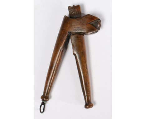 Carved with a stylized bud, each arm with a squat-ball terminal, 16cm long   Literature: See A. Wagner, 'The Art & Character 