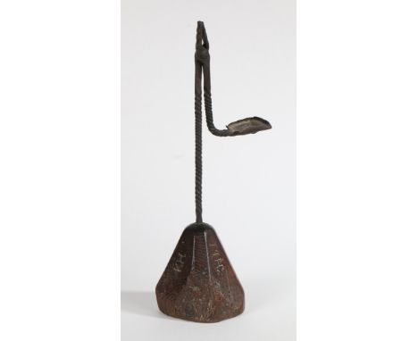 With short filed jaws, tight twist-work steam and arm, the latter with rectangular pan counterweight, on a facetted ash base,