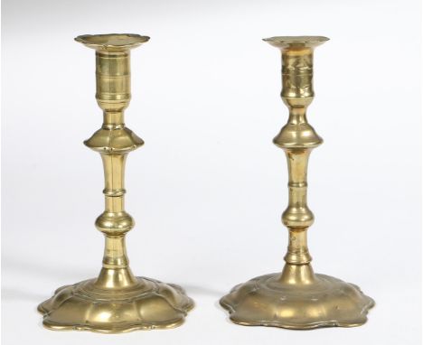 Seamed, each with a cusped flange and cylindrical socket with central narrow fillet, rising-baluster fluted stem, on a spread