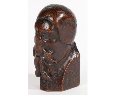 Modelled with full-beard and moustache, wearing a skull-cap, possibly an end finial from a pew, height 15cm.