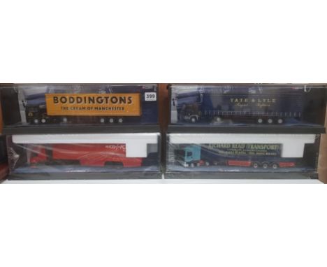 4 CORGI TRUCKS IN DISPLAY CASES