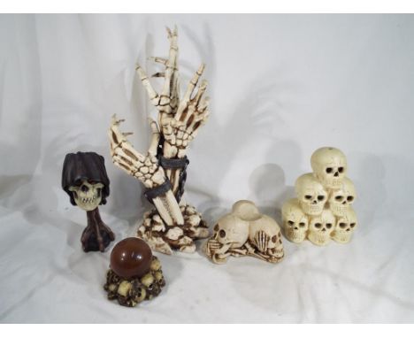 Gothic / Halloween interest - a collection of novelty skulls to include The Reaper's Stare candle holder, Skeleton Hand drink