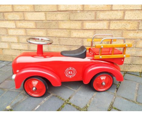 A child's sit-on red Fire Engine, unused, mint, approx 74 cm (length) - Est £40 - £60