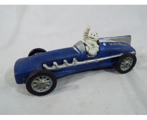 A cast iron model depicting a blue Hubley 1934 racing car driven by the Michelin Man, approx 25 cm (length) - Est £20 - £40