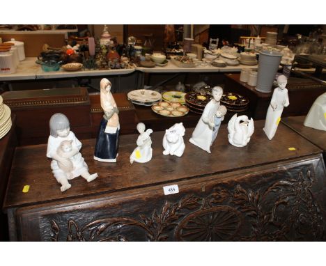 A collection of Nao figures, Crown Staffordshire swan, Moments by Coalport "Playtime " etc.