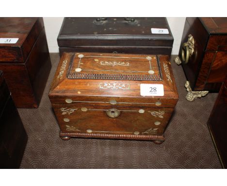 A 19th Century rosewood and mother of pearl inlaid sarcophagus two compartment tea caddy, flanked by ring handles 