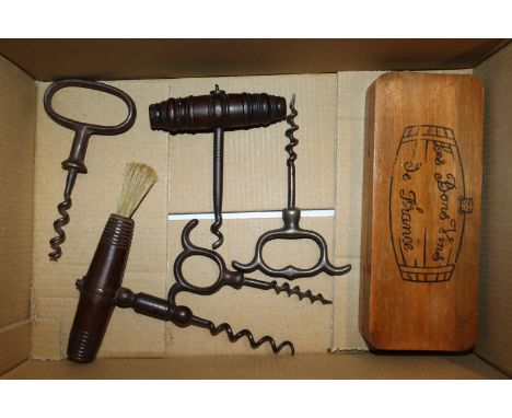 A box containing antique corkscrews and a wine thermometer