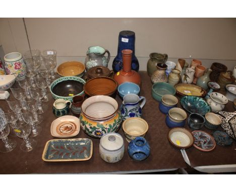 A terracotta decanter; a collection of various Studio Pottery to include table lamp base, jardinieres, preserve pot etc.