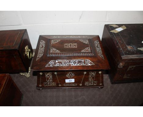 An antique rosewood mother of pearl inlaid sewing box of sarcophagus for, flanked by ring handles 