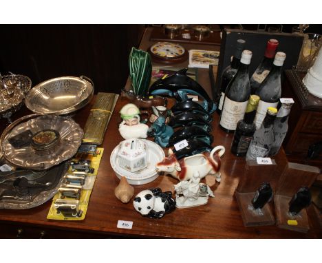 A collection of Poole Pottery dolphins; a Poole pottery otter; a Beswick Panda bear; a Goebel cow creamer; a Beswick sheep; c