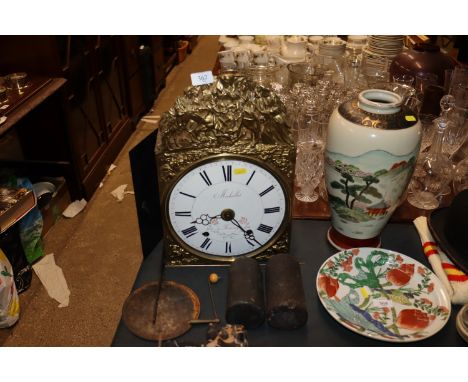 A 19th Century Comtoise of shelf clock complete with weights, key, pendulum, circular enamel dial, the brass mounts decorated