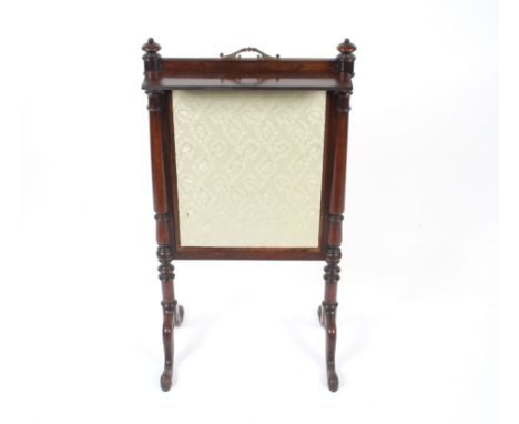 A small Victorian rosewood fire screen with embroidered pull up panel, a small detachable shelf raised on turned columns and 