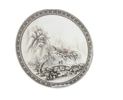 EARLY 20TH CENTURY CHINESE CIRCULAR PLATEdecorated with a winter scene of figures and pavillions in a mountainous landscape, 