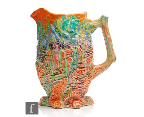 A Clarice Cliff relief moulded jug, hand painted in the Delecia pattern with tonal streaked glaze in orange, green, blue and 
