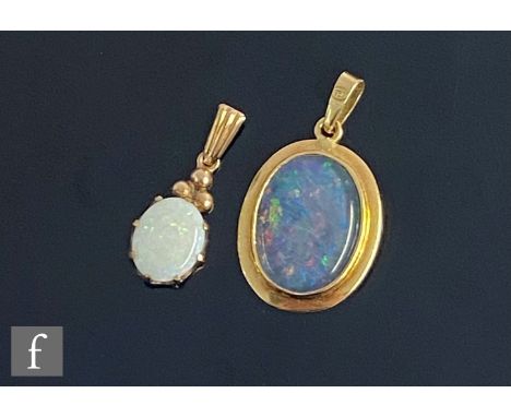 An 18ct mounted opal doublet pendant, weight 3g, length 3cm, with a similar 9ct opal pendant, weight 1.3g, length 2cm. (2) 