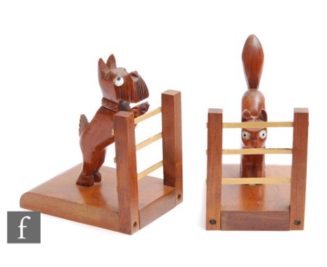 A pair of 20th Century wooden bookends, the first modelled as a scotty dog looking over the gate and the second a stylised ca