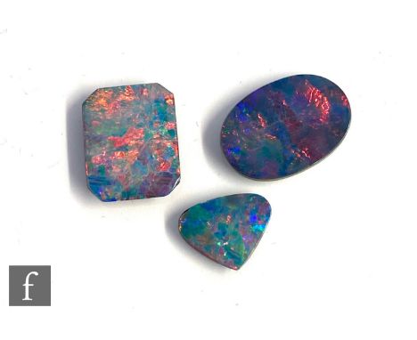 Three cut and polished loose, unused opal doublet stones, oval, canted rectangular and cushioned triangular examples, largest