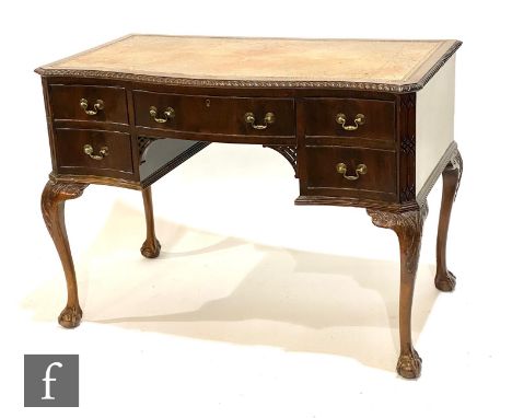 An Edwardian mahogany serpentine Chippendale style kneehole desk, fitted with five drawers below a gadrooned edge and pale le