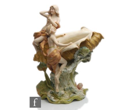 A large early 20th Century Royal Dux Art Nouveau table centre comport modelled as two scantily clad females climbing and perc
